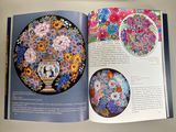 an open book with a picture of a vase and flowers on it