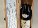 a bottle of wine in a wooden box on a table