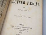 an old book opened to show the title of a novel
