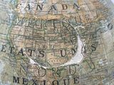a large globe with a map on top of it