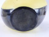 a yellow and black bowl with a black lid