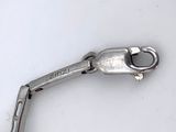 a small metal object that is on a white surface