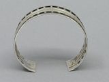 silver cuff bracelet with black and white design