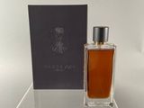 a bottle of perfume sitting on top of a clear table