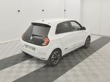 a picture of a small white car parked in a garage