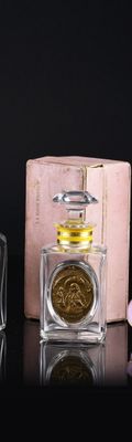 three perfume bottles sitting next to each other on a table