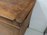 a wooden chest with a drawer on top of it