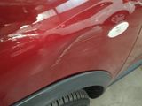 a close up of a red car with a white sticker on it