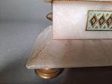 a white marble box with a gold and blue design on it