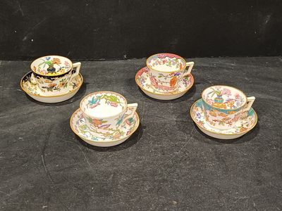 three tea cups and saucers are sitting on a black surface