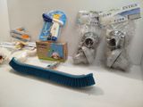 a broom, brush, toothbrush, and toothpaste on a counter