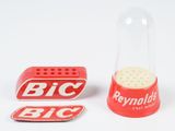a small red pepper shaker next to a small red pepper shaker