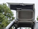 a white car with its door open and a black seat
