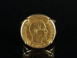 a close up of a gold coin on a black surface