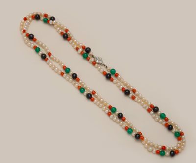 a close up of a beaded necklace on a white surface