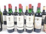 several bottles of wine are lined up in a row on a white surface