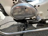 a close up view of a motorcycle ' s engine and exhaust pipe