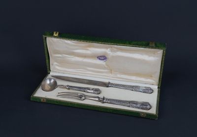 a silverware set in a green case on a black background