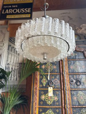 a glass chandelier hanging from a ceiling in a room