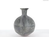 a black vase that is sitting on a table