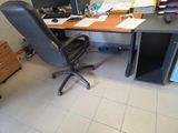 a desk with a chair and a computer on it
