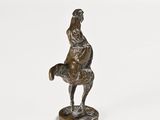 a bronze figurine of a man on a horse
