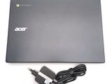 a black laptop with a charger and a power cord