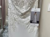 the wedding dress is hanging on the rack in the store