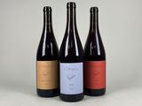 three bottles of wine sitting next to each other on a table