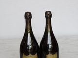 two bottles of champagne sitting on top of a marble counter top