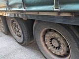 a truck that has a green tarp on the side of it