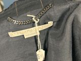 a close up of a black shirt with a chain on it
