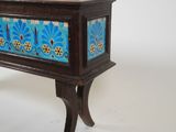a small wooden table with a blue and yellow design on it