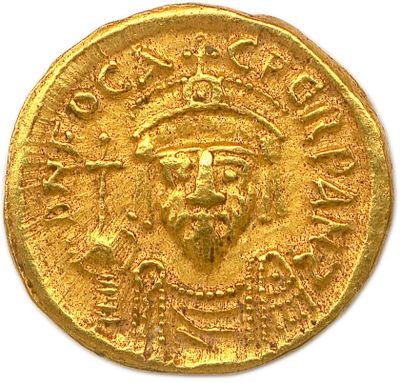 a close up of a gold coin with an image of a man on it