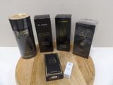 three boxes of perfume sitting on top of a wooden table