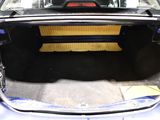 the back of a car with its trunk open and a seat folded down