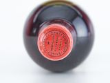 a close up of a wine bottle with a red label