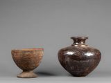 two vases sitting next to each other on a table