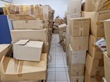 many boxes stacked on top of each other in a room