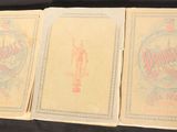 three old playing cards sitting on top of a black table