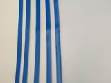 a close up of a piece of blue plastic on a white wall