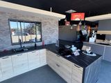 a kitchen with a black counter top and a black counter top