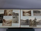 an old photo of a book with pictures of mountains in it