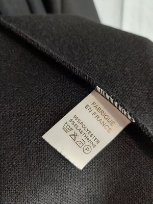 a close up of a label on a black jacket