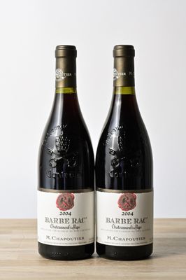 two bottles of wine sitting on top of a table next to each other