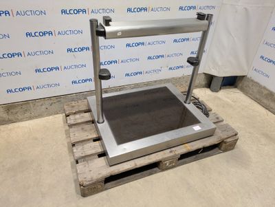a large scale sitting on top of a pallet in front of a wall