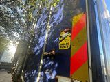 a blue truck with a yellow and red stripe on the back