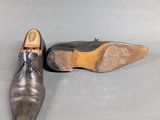 pair of men ' s shoes on a grey surface