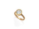 a gold ring with a blue topaz stone and a black diamond