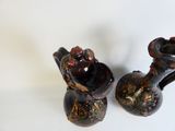 two vases that are sitting on a white surface